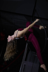 Fototapeta na wymiar Young beautiful girl air gymnastics coach, workout ring, stretching, poledance, dance studio, movement
