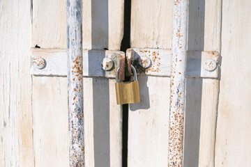 white wooden door with padlock