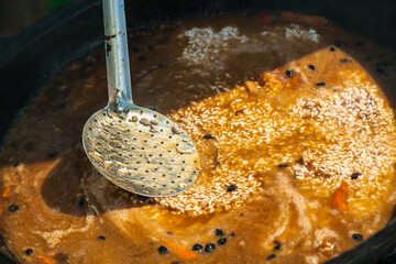 Hot pilaf in large cauldron outdoors. Tasty pilaf at street.