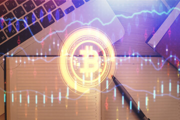 Blockchain theme hologram drawings over computer on the desktop background. Top view. Double...