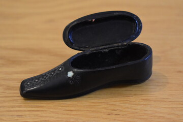 Ornate black shoe shaped snuffbox produced to keep the powder dry It holds few days tobacco supply...