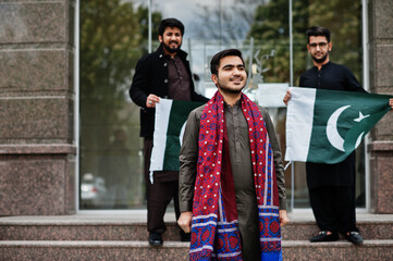 Fototapeta premium Group of pakistani man wearing traditional clothes salwar kameez or kurta with Pakistan flags.