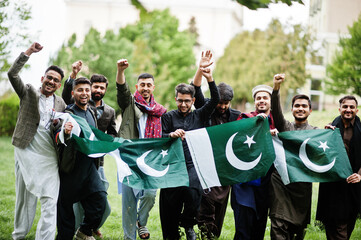 Group of pakistani man wearing traditional clothes salwar kameez or kurta with Pakistan flags. - obrazy, fototapety, plakaty