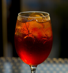 Traditional italian summer drink: aperol spritz with prosecco wine. Served with black straw, slice...