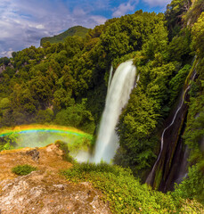 A long exposure view showing the colours of the rainbow produced by the spray from upper waterfalls at Marmore, Umbria, Italy in summer