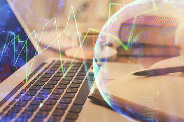 Double exposure of financial chart drawing and desktop with coffee and items on table background. Concept of forex market trading