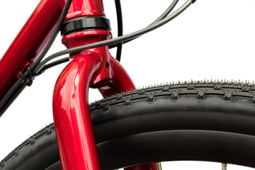 Close-up front part of a red shiny bike with a rigid fork on a white background © Chinart