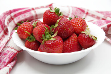 Strawberries in a bowl isolated on a white background. Red strawberries on a white background