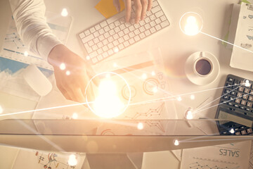 Naklejka premium Double exposure of man's hands typing over computer keyboard and social network theme hologram drawing. Top view. People connection web concept.