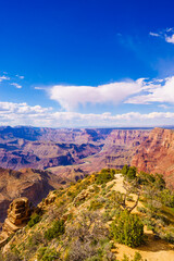 Fototapeta na wymiar Panoramic image of the colorful Sunset on the Grand Canyon in Grand Canyon National Park from the south rim part,Arizona,USA, on a sunny cloudy day with blue or gloden sky