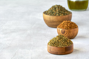 Mixed spice zaatar or zatar in wooden bowls, Various type of zaatar blend. Close up with copy space