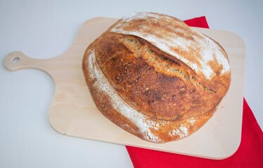 loaf of homemade bread on the wooden plate