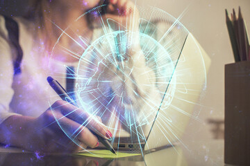 Multi exposure of woman hands typing on computer and business theme hologram drawing. Success concept.