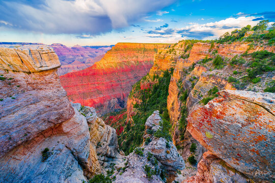 Panoramic image of the colorful Sunset on the Grand Canyon in Grand Canyon National Park from the south rim part,Arizona,USA, on a sunny cloudy day with blue or gloden sky