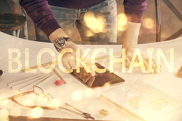 Double exposure of man's hands holding and using a phone and crypto currency blockchain theme drawing.