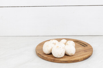 Mushrooms on the wooden cutting board with copy space