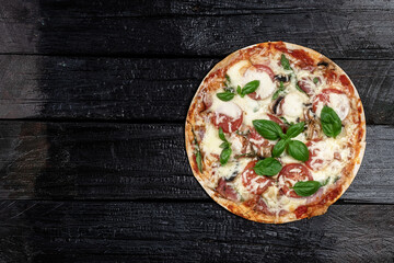 Pizza on dark wooden background