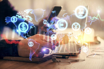 Double exposure of man's hands holding and using a phone and financial graph drawing. Analysis concept.