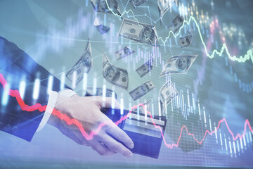 Multi exposure of financial graph drawing hologram and USA dollars bills and man hands. Analysis concept.