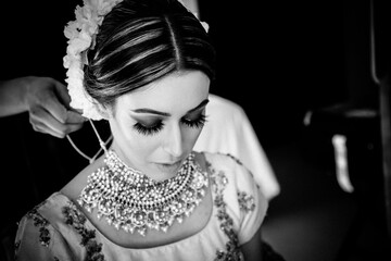 Beautiful female model wearing traditional Sikh wedding attire as she prepares for the ceremony