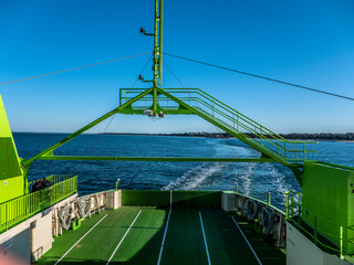 Troia, Setubal, Portugal - March 8, 2020 - Ferry boat crossing Sado River. Sunny day on a green sea...