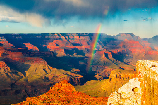 Panoramic image of the colorful rainbow over the Grand Canyon in Grand Canyon National Park from the south rim part,Arizona,USA, sunset on a sunny cloudy day with blue sky