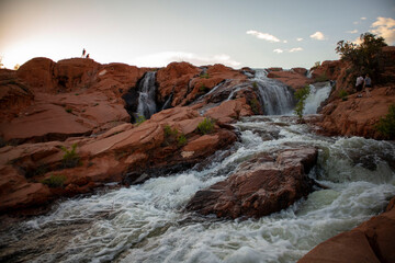 Fototapeta na wymiar waterfall in the mountain red rocks