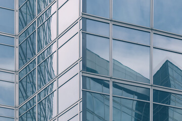 Fototapeta na wymiar modern office glass building texture in light blue tones for business background, business center generic facade, corner view