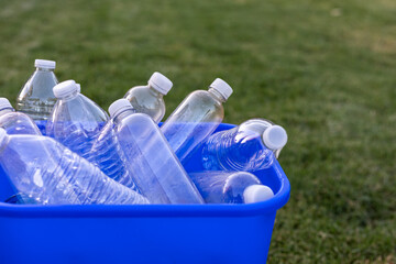Blue recycling can full of empty plastic water bottles © MaryHerronPhoto