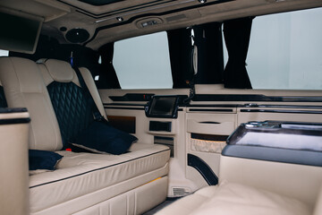 Luxury leather seats in the comfortable van. Interior of luxury minivan with backlight, transfer car