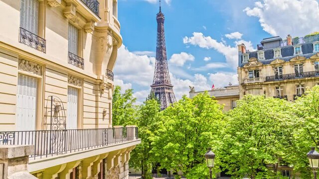 Romantic cozy view of the famous Eiffel tower from a small paris street on a cloudy sunny day in spring summer - wide horizontal panorama.From the Avenue de Camoens
