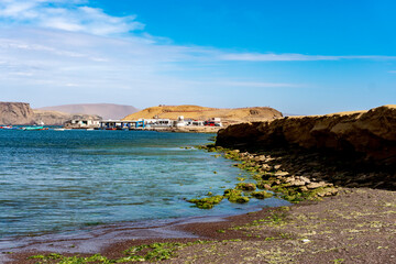 sunny day on the beach of lagunillas observing rocks on the shore of the beach and blue sky, which is a spa located in the district and province of Pisco