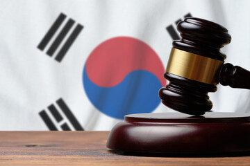 Justice and court concept in South Korea. Judge hammer on a flag background