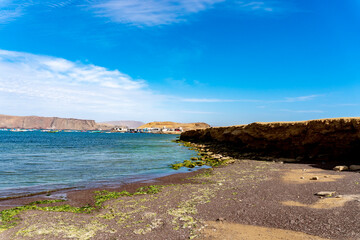 sunny day on the beach of lagunillas observing rocks on the shore of the beach, which is a spa located in the district and province of Pisco