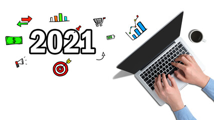 The concept of new achievements and ideas in 2021. Hands typed on a laptop with graphic icons next to it.