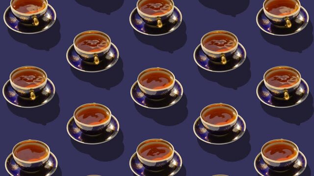 Background from large group of cups with tea. Stop motion animation. Ceramic cups revolve around their axes.  Flat lay, top view. Diagonal isometric view. Seamless loop video. 