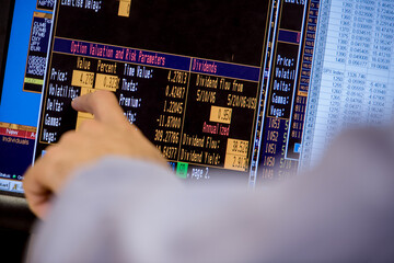 Close-up details on stock trading floor computer screens