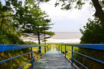Old painted stairs leading to the ocean. Best way finding concept