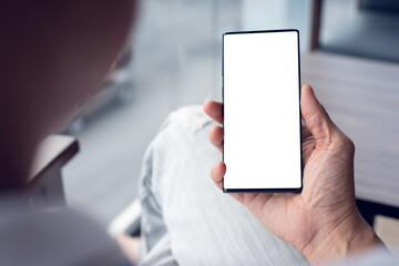 Mockup of man using blank screen phone in cafe