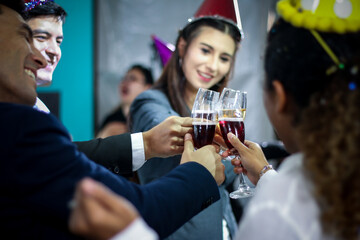 Business people or team or friend or colleagues are drinking together with glass of champagne or alcohol in party after work, happy new year celebration fun in office