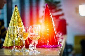 Business people or team or friend or colleagues are drinking together with glass of champagne or alcohol in party after work, happy new year celebration fun in office