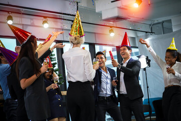 Business people or team or friend or colleagues are drinking together with glass of champagne or alcohol in party after work, happy new year celebration fun in office