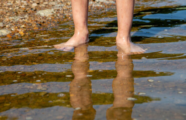 body parts feet are in the water
