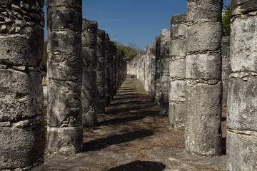 Fototapeta na wymiar Mayan ancient city ruins. Columns in Temple of the Warriors in Chichen Itza archaeological site, Yucatan, Mexico.