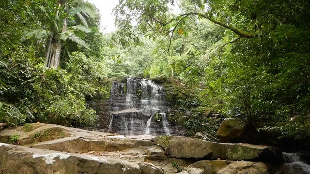 Hidden Waterfall between Rocks in Borneo Rainforest