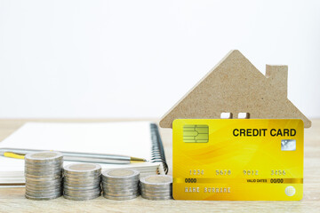 House model and credit card on table