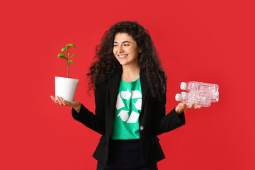 Woman wearing t-shirt with recycling sign, trash and plant on color background. Ecology concept
