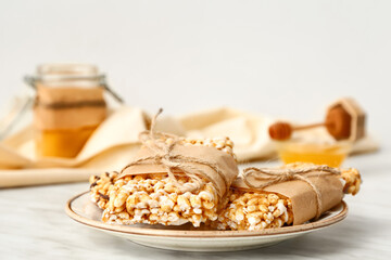 Plate with crispy rice bars on table