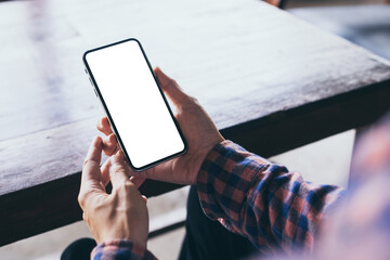 cell phone mockup image blank white screen.woman hand holding texting using mobile on desk at coffee shop.background empty space for advertise.work people contact marketing business,technology