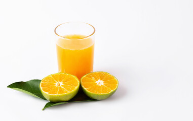 Jug, glass of orange juice and orange fruits with green leaves  on white background